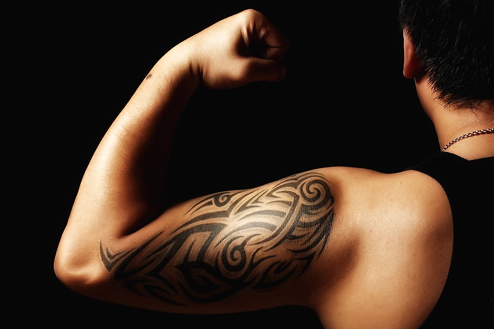 Tattooed arm flexing a bicep