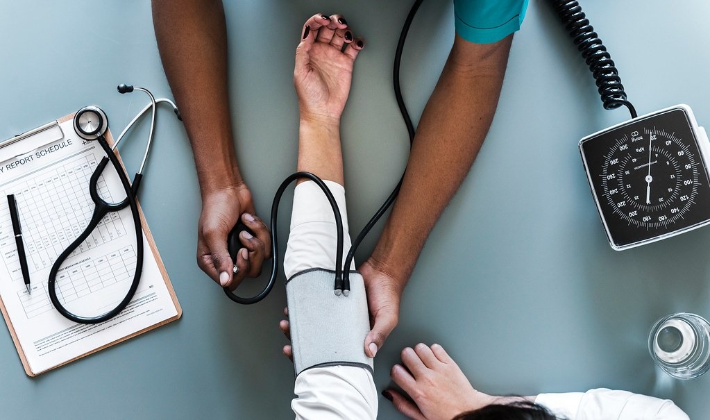 Checking blood pressure with a cuff and stethoscope