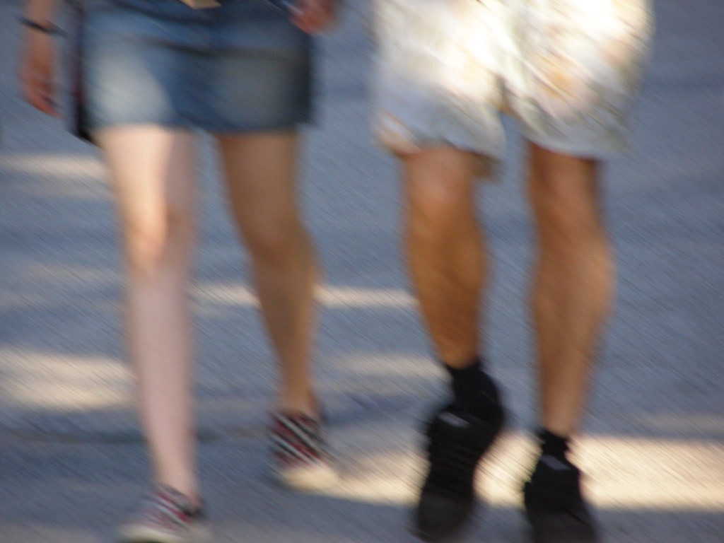Two people walking with bare knees