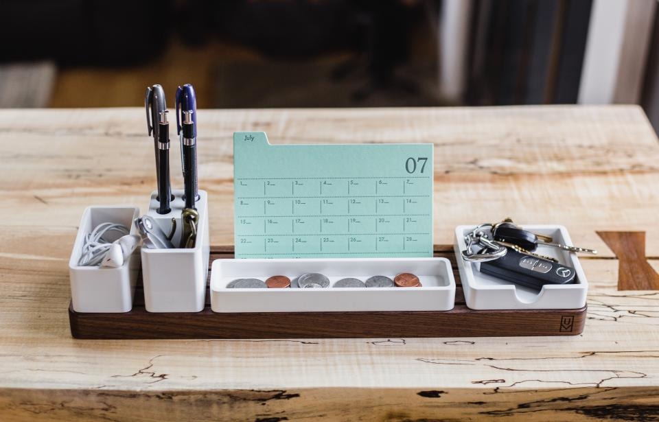 Desk calendar and pens on a wooden desk