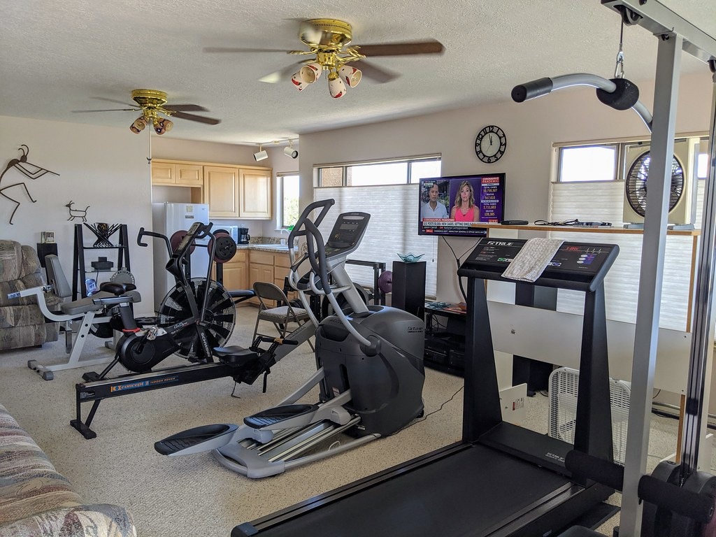 Home gym with cardio machines and weights