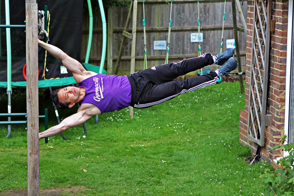 Man holding a human flag on a pole