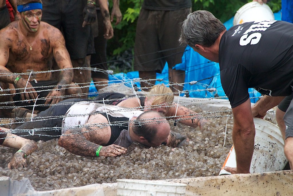 Racers climbing through an ice bath at an Ontario obstacle race