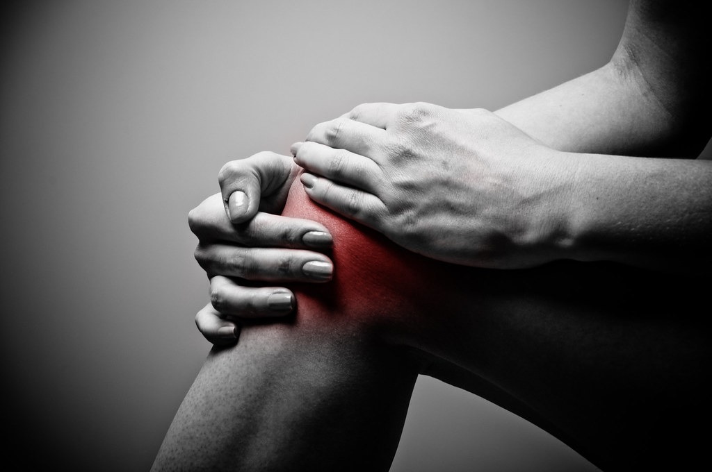 Man holding a sore knee
