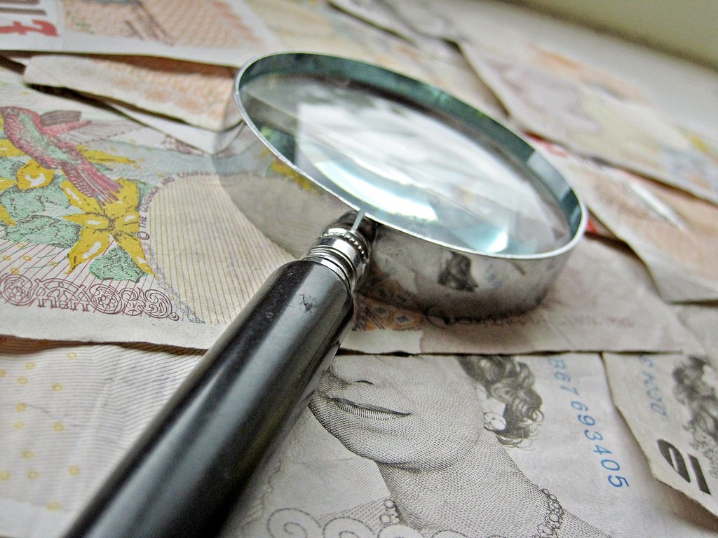 Magnifying glass over banknotes