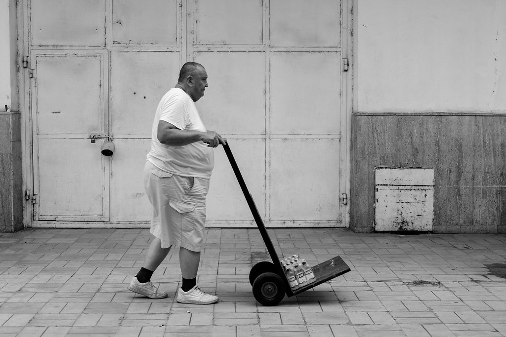 Man pushing a weighted sled in a gym