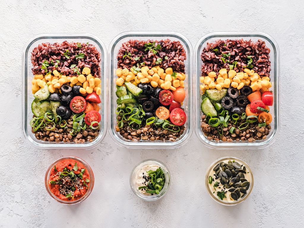 Glass meal prep containers with grains and vegetables
