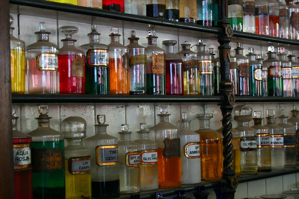 Pharmacy shelves lined with medicine bottles