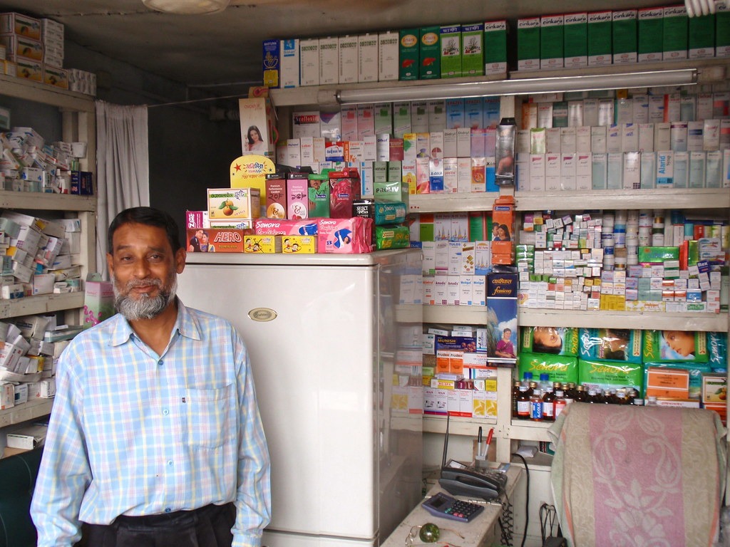 Pharmacist standing in a small pharmacy