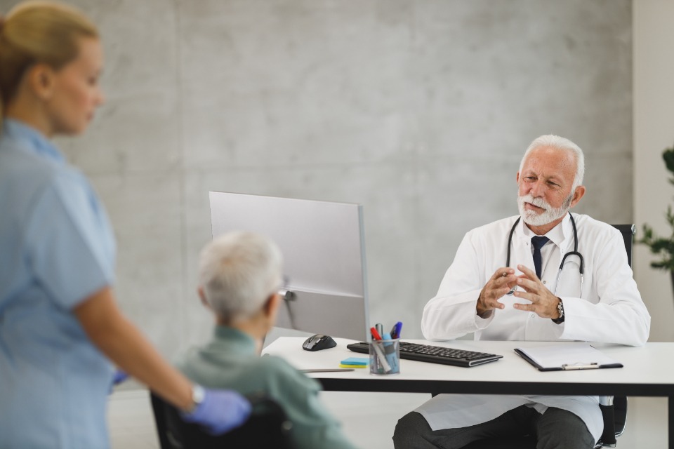 Doctor talking with a patient at a desk