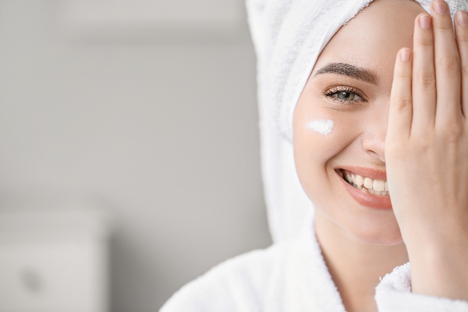 Applying skin cream to the face