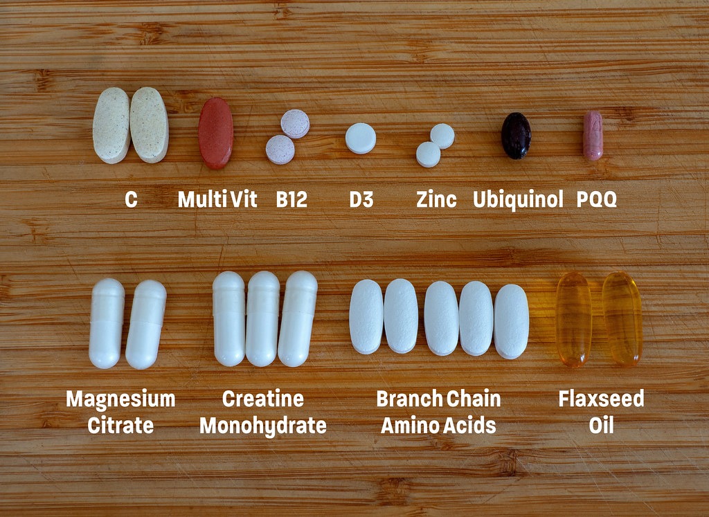 Daily supplements laid out with labels, including branched-chain amino acids