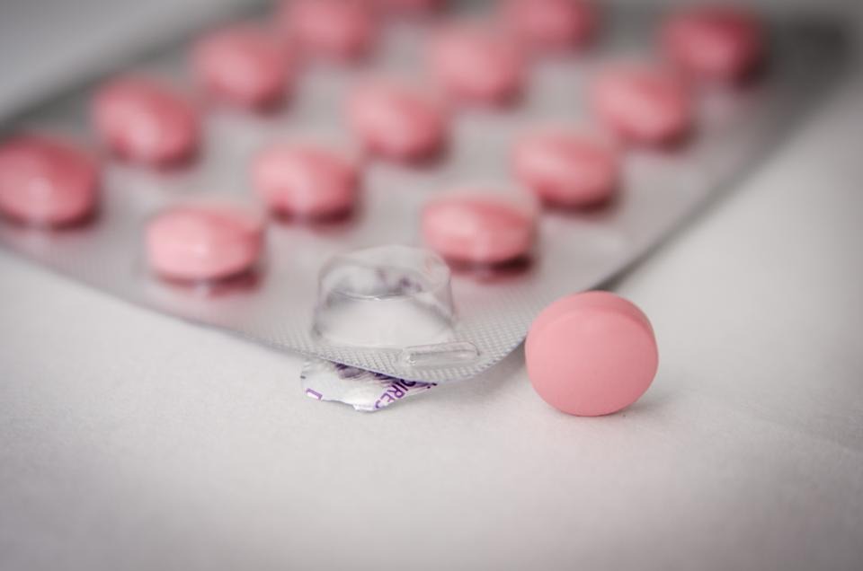 Pink medicine tablets in a blister pack