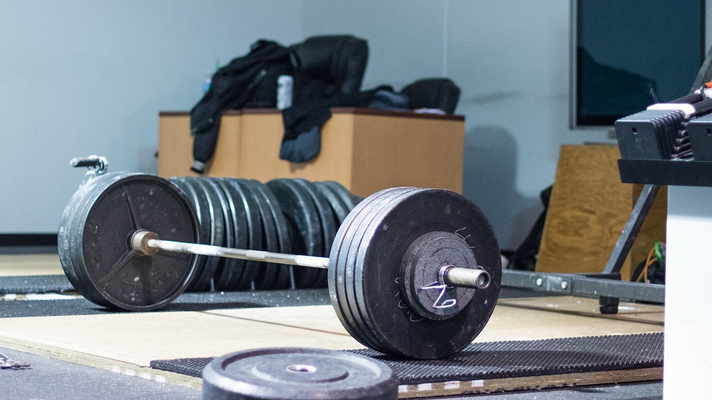Loaded barbell on a gym floor